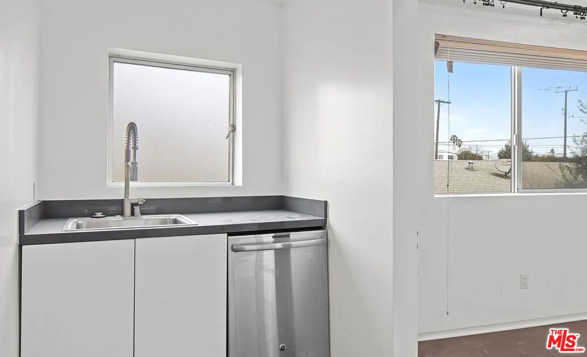 615 6th Avenue, Unit 1/2 Venice, CA 90291 - Photo 23 of 44 a bathroom with a granite countertop sink and a mirror