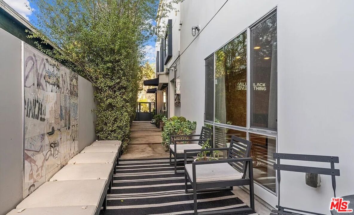615 6th Avenue, Unit 1/2 Venice, CA 90291 - Photo 36 of 44 a view of a patio with table and chairs with wooden floor and plants