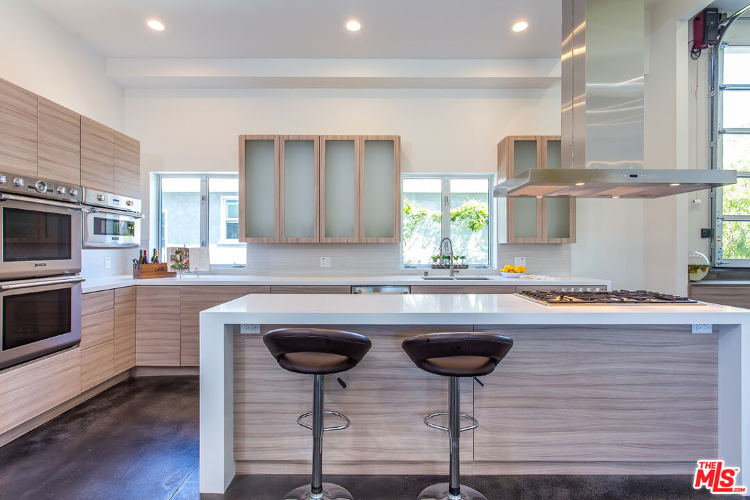 615 6th Avenue, Unit 1/2 Venice, CA 90291 - Photo 7 of 44 a kitchen with stainless steel appliances granite countertop a sink a stove a microwave a refrigerator and cabinets