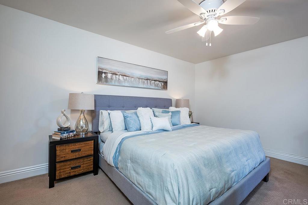 3688 1st Avenue, Unit 15 San Diego, CA 92103 - Photo 15 of 35 a bedroom with a bed and a chandelier