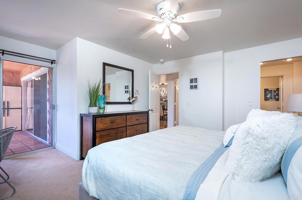 3688 1st Avenue, Unit 15 San Diego, CA 92103 - Photo 16 of 35 a bedroom with a bed and a chandelier