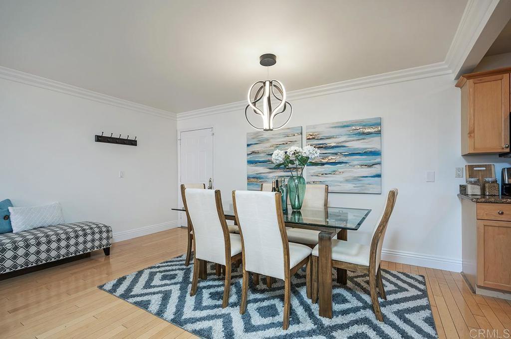 3688 1st Avenue, Unit 15 San Diego, CA 92103 - Photo 3 of 35 a view of a dining room with furniture and wooden floor