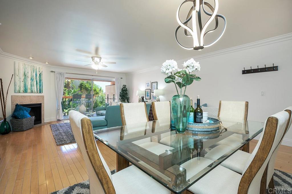3688 1st Avenue, Unit 15 San Diego, CA 92103 - Photo 4 of 35 a view of a dining room with furniture a chandelier and wooden floor
