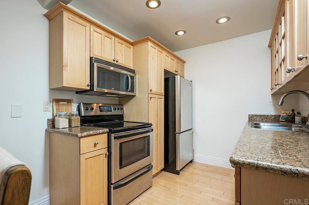 3688 1st Avenue, Unit 15 San Diego, CA 92103 - Photo 5 of 35 a kitchen with granite countertop a sink stove and refrigerator