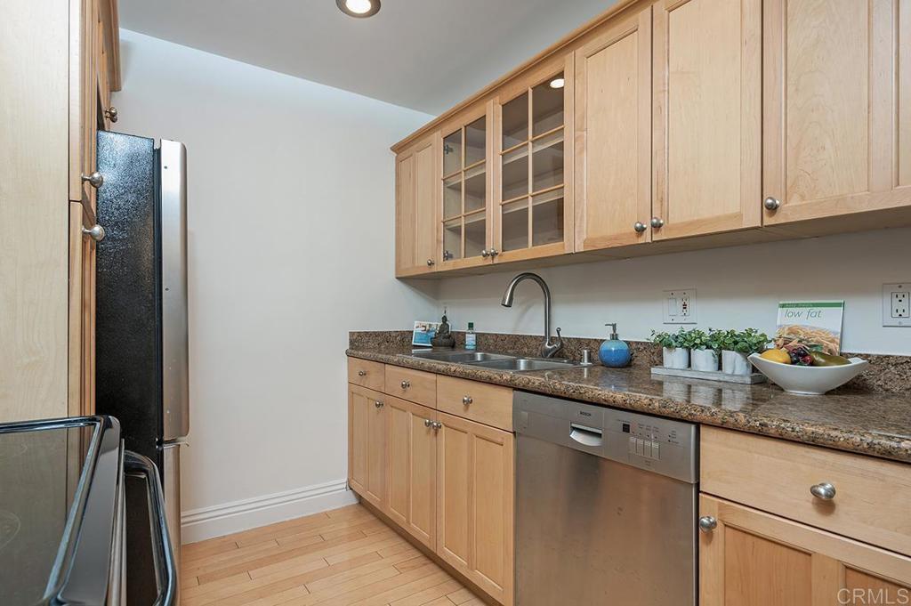 3688 1st Avenue, Unit 15 San Diego, CA 92103 - Photo 6 of 35 a kitchen with stainless steel appliances granite countertop a sink stove and cabinets