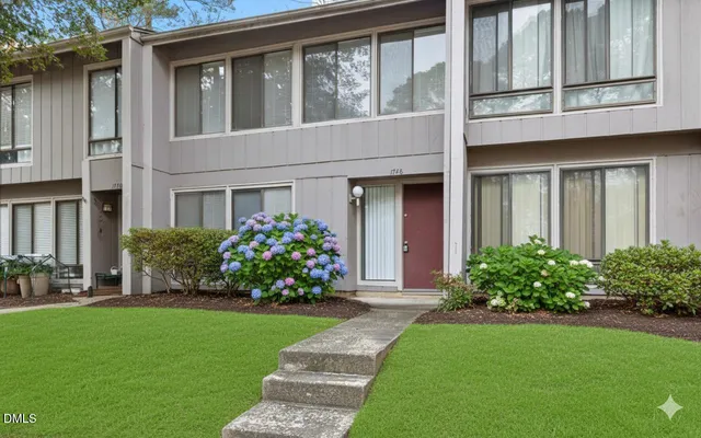 a front view of a house with a garden