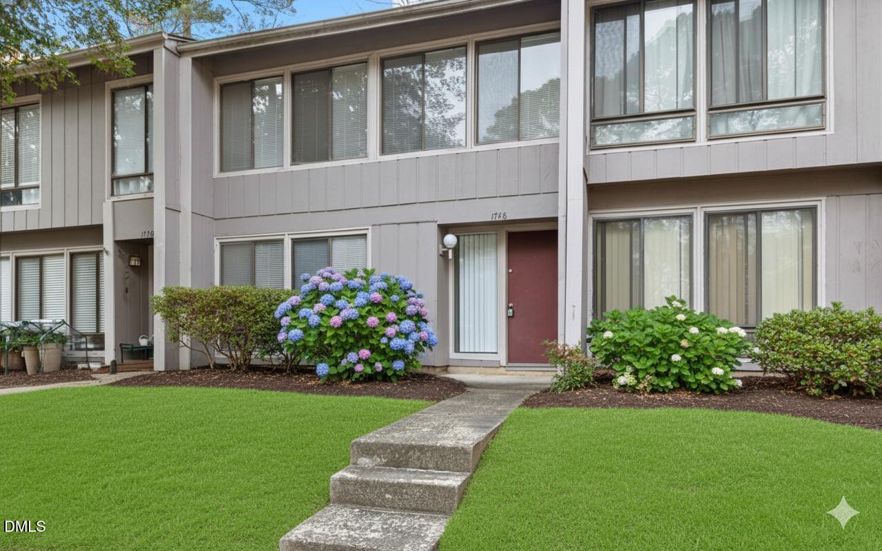 1748 Quail Ridge Road Raleigh, NC 27609 - Photo 1 of 36 a front view of a house with a garden