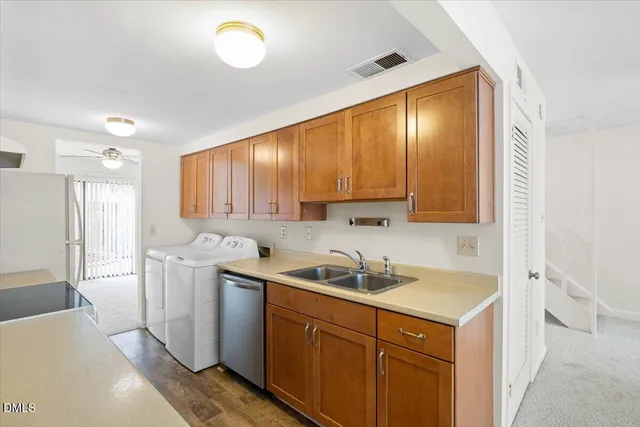 a kitchen with a sink stove top oven and refrigerator