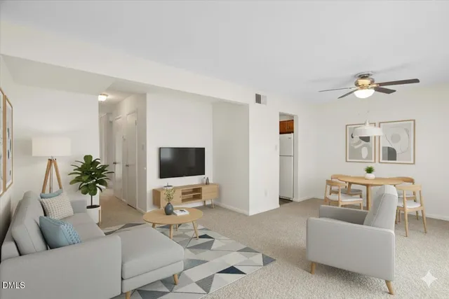 an empty room with closet and a ceiling fan