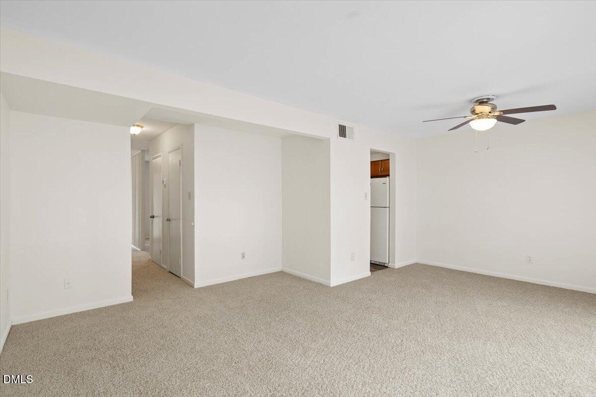 1748 Quail Ridge Road Raleigh, NC 27609 - Photo 18 of 36 an empty room with a ceiling fan
