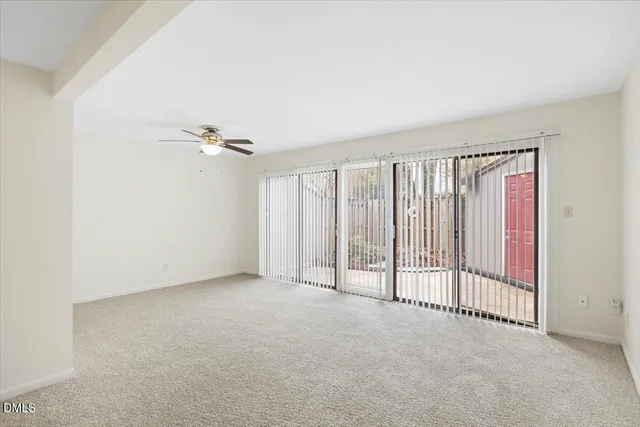 a living room with furniture a flat screen tv and a large window