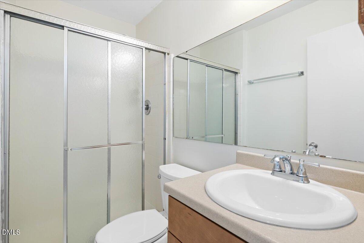 1748 Quail Ridge Road Raleigh, NC 27609 - Photo 26 of 36 a bathroom with a sink and a mirror