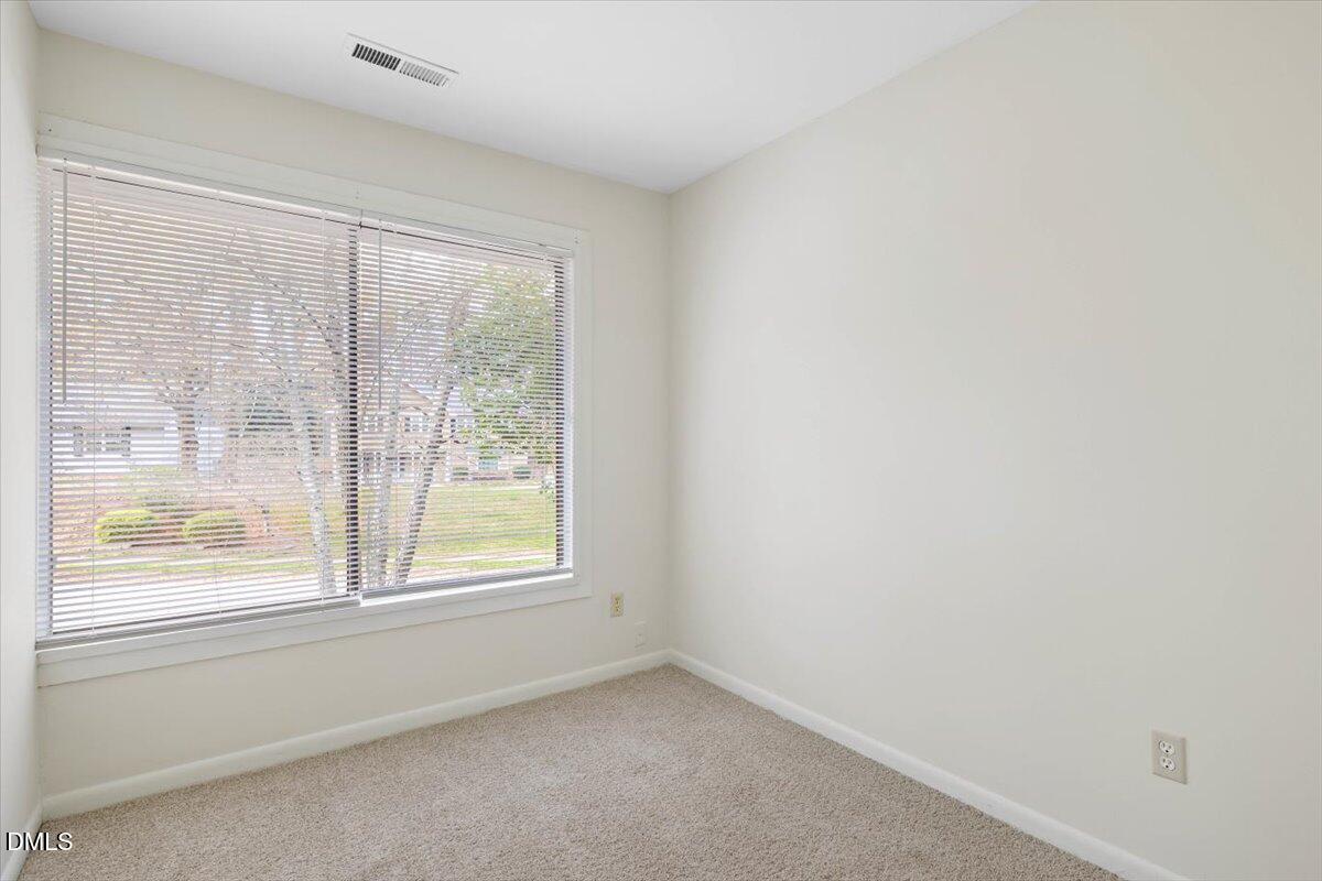 1748 Quail Ridge Road Raleigh, NC 27609 - Photo 31 of 36 an empty room with windows