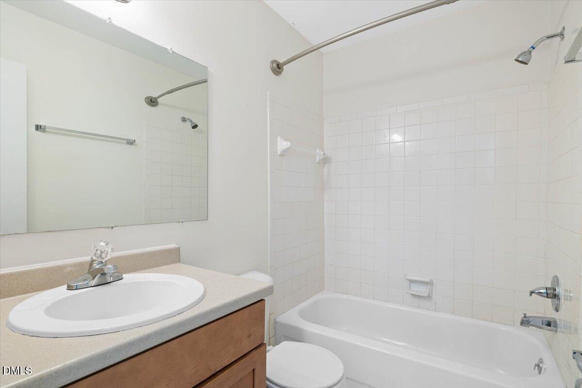 1748 Quail Ridge Road Raleigh, NC 27609 - Photo 33 of 36 a bathroom with a granite countertop sink toilet and shower