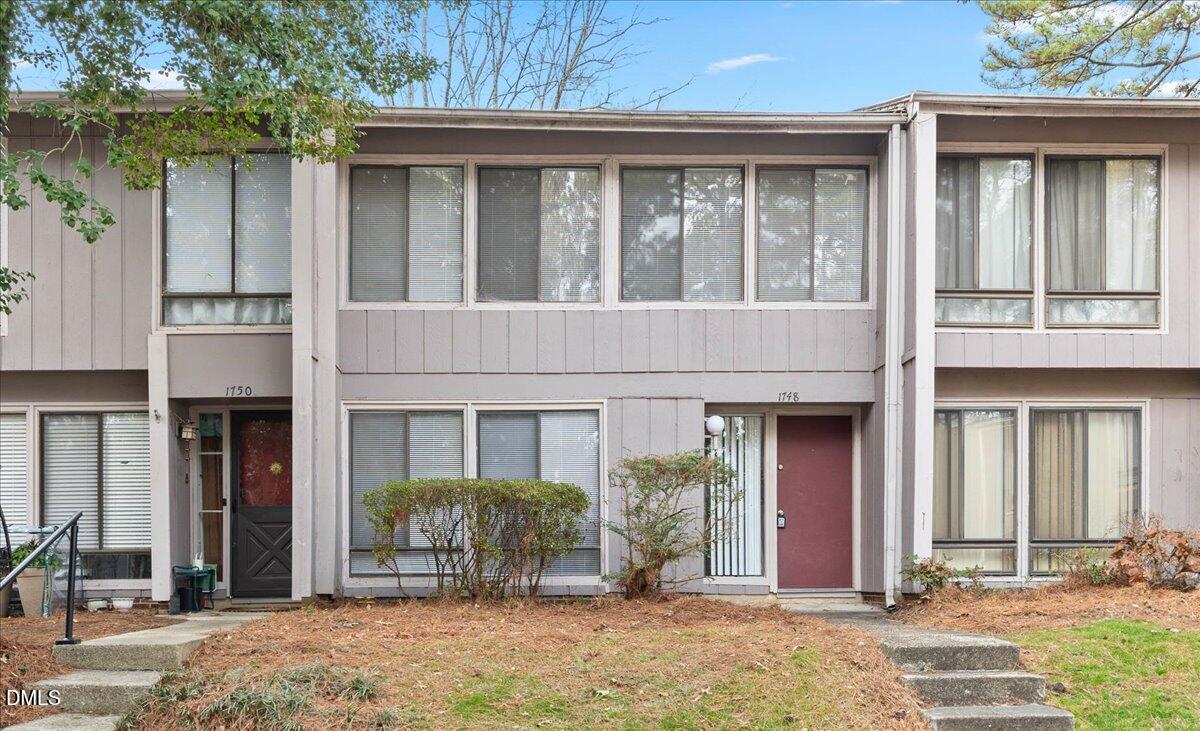1748 Quail Ridge Road Raleigh, NC 27609 - Photo 5 of 36 front view of a brick house with a large windows