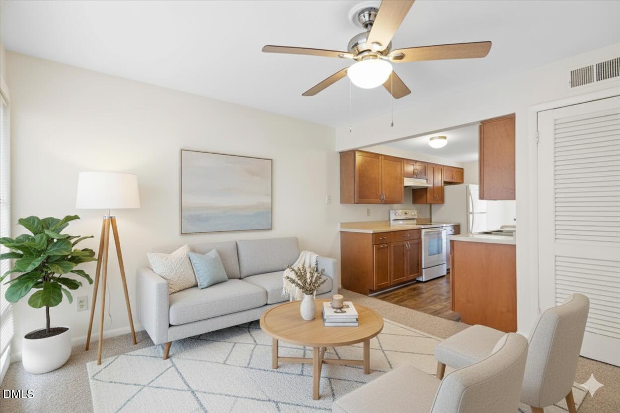 1748 Quail Ridge Road Raleigh, NC 27609 - Photo 9 of 36 a living room with furniture and a potted plant