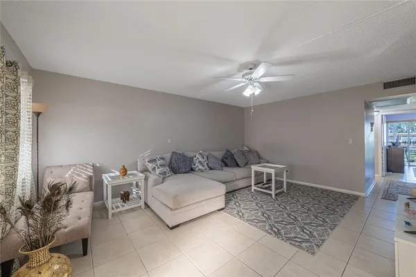 a living room with furniture and a ceiling fan