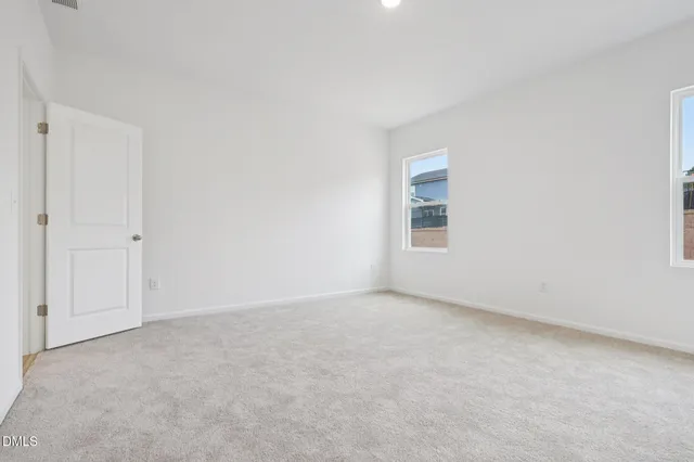 an empty room with a empty space and windows