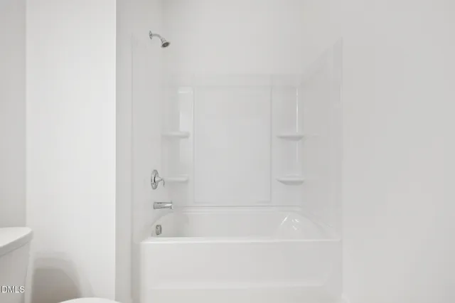 a view of house with backyard and trees in the background