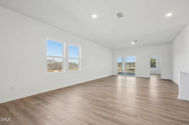 a view of a livingroom with wooden floor and a window