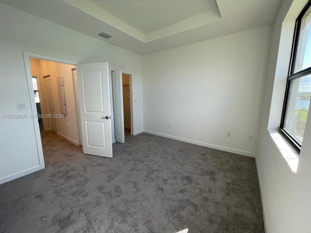 10144 Southwest 228th Terrace Miami, FL 33190 - Photo 17 of 23 an empty room with windows