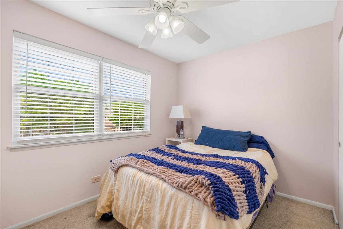 642 Dunham Road Gurnee, IL 60031 - Photo 13 of 33 a bedroom with a bed and a chandelier