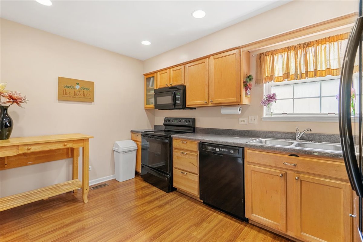 642 Dunham Road Gurnee, IL 60031 - Photo 5 of 33 a kitchen with stainless steel appliances granite countertop a stove a sink and a microwave