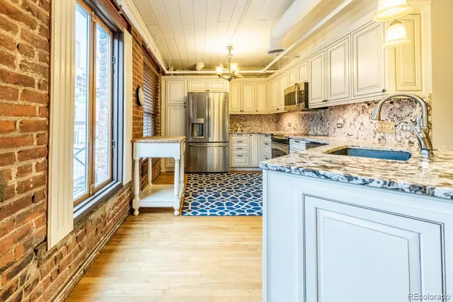 a view of a room with wooden floor and windows