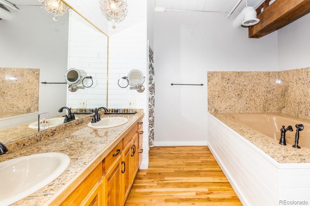 1940 Blake Street, Unit 301 Denver, CO 80202 - Photo 19 of 25 a bathroom with a tub sink and mirror