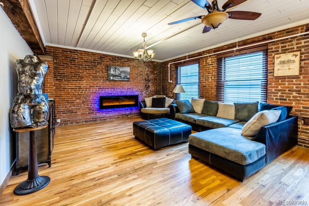 1940 Blake Street, Unit 301 Denver, CO 80202 - Photo 2 of 25 a living room with furniture and a fireplace