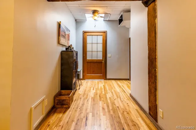 a view of a hallway with wooden floor and staircase