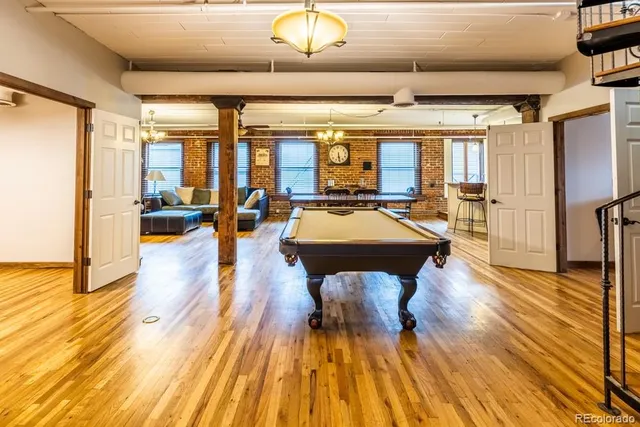 a living room with fireplace furniture and a chandelier