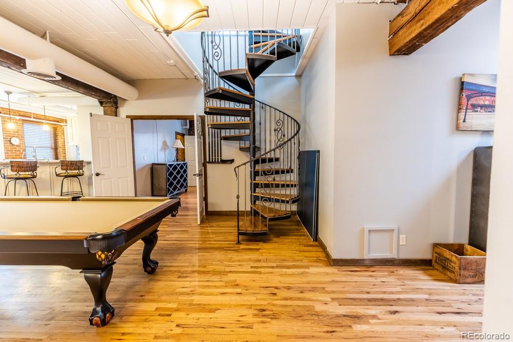 1940 Blake Street, Unit 301 Denver, CO 80202 - Photo 8 of 25 a view of a hallway with wooden floor and staircase