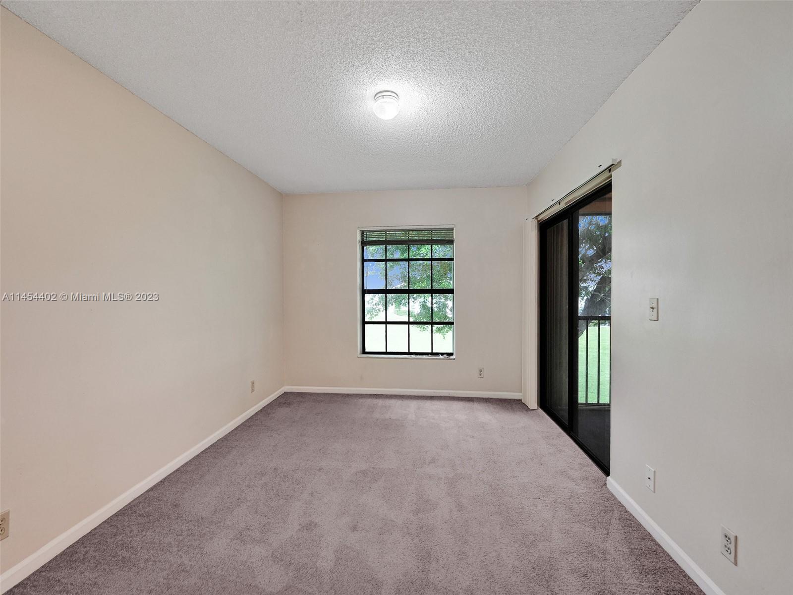 321 Olivewood Place, Unit O221 Boca Raton, FL 33431 - Photo 11 of 56 an empty room with windows