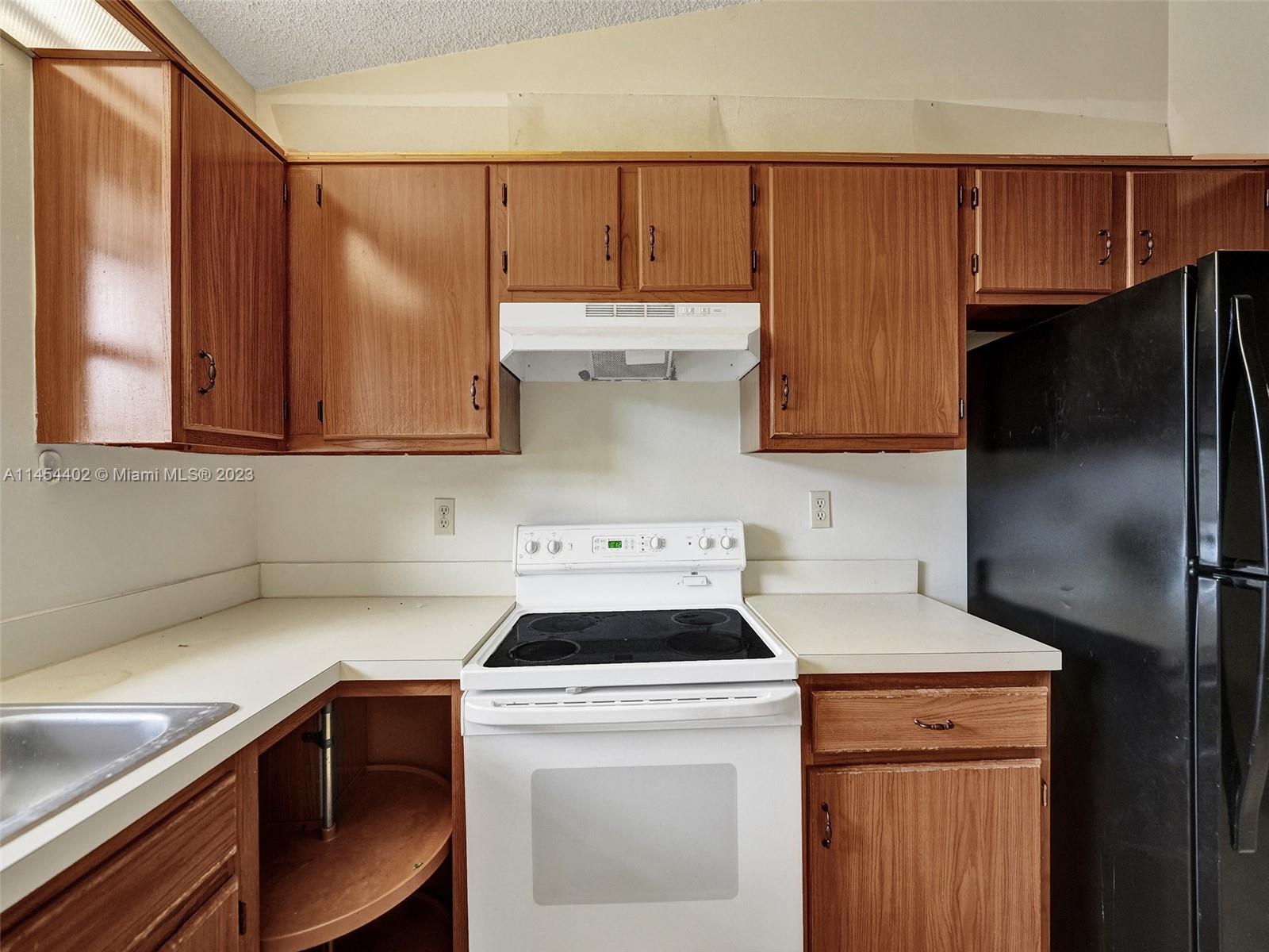 321 Olivewood Place, Unit O221 Boca Raton, FL 33431 - Photo 20 of 56 a kitchen with a sink cabinets and stainless steel appliances