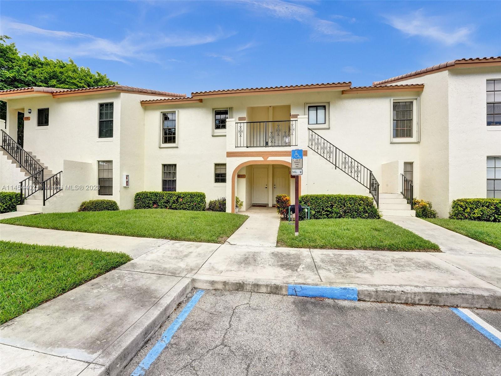 321 Olivewood Place, Unit O221 Boca Raton, FL 33431 - Photo 2 of 56 a front view of a house with a yard and garage