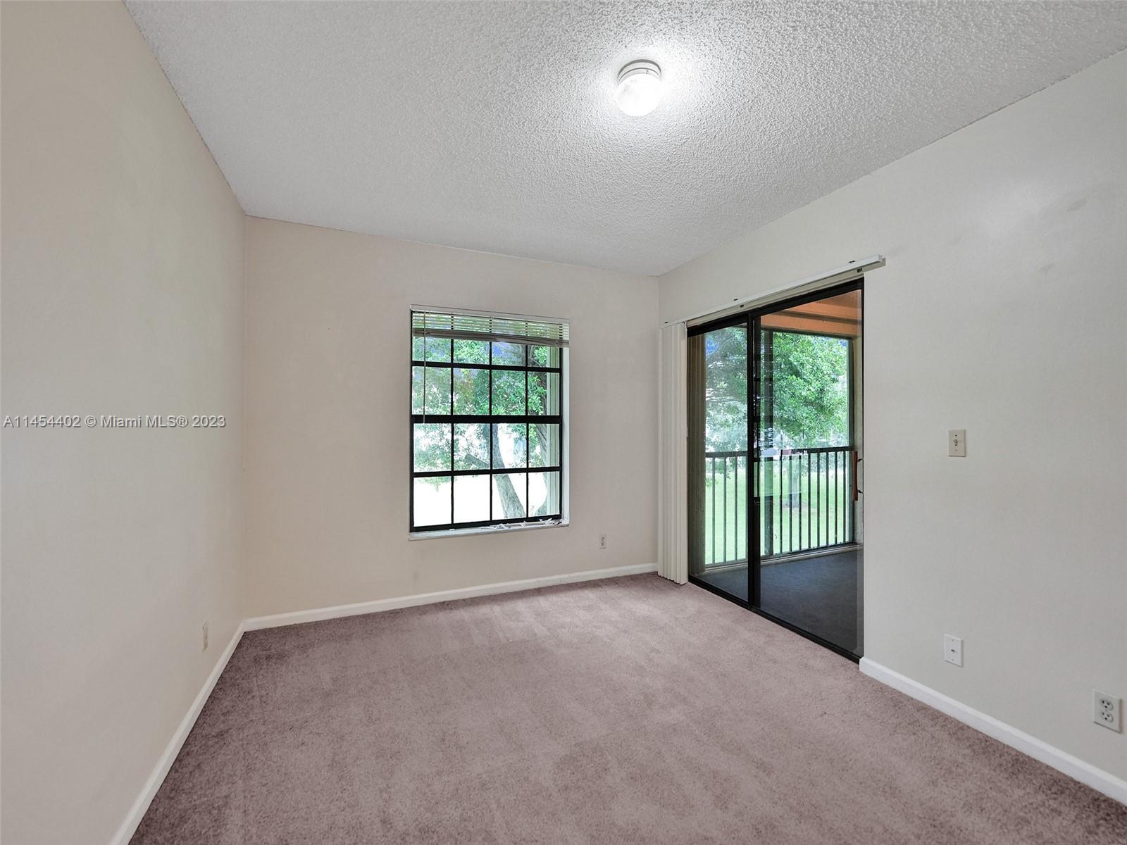 321 Olivewood Place, Unit O221 Boca Raton, FL 33431 - Photo 22 of 56 an empty room with windows