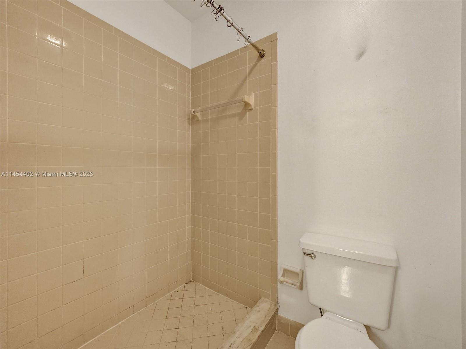 321 Olivewood Place, Unit O221 Boca Raton, FL 33431 - Photo 30 of 56 a white toilet sitting next to a shower