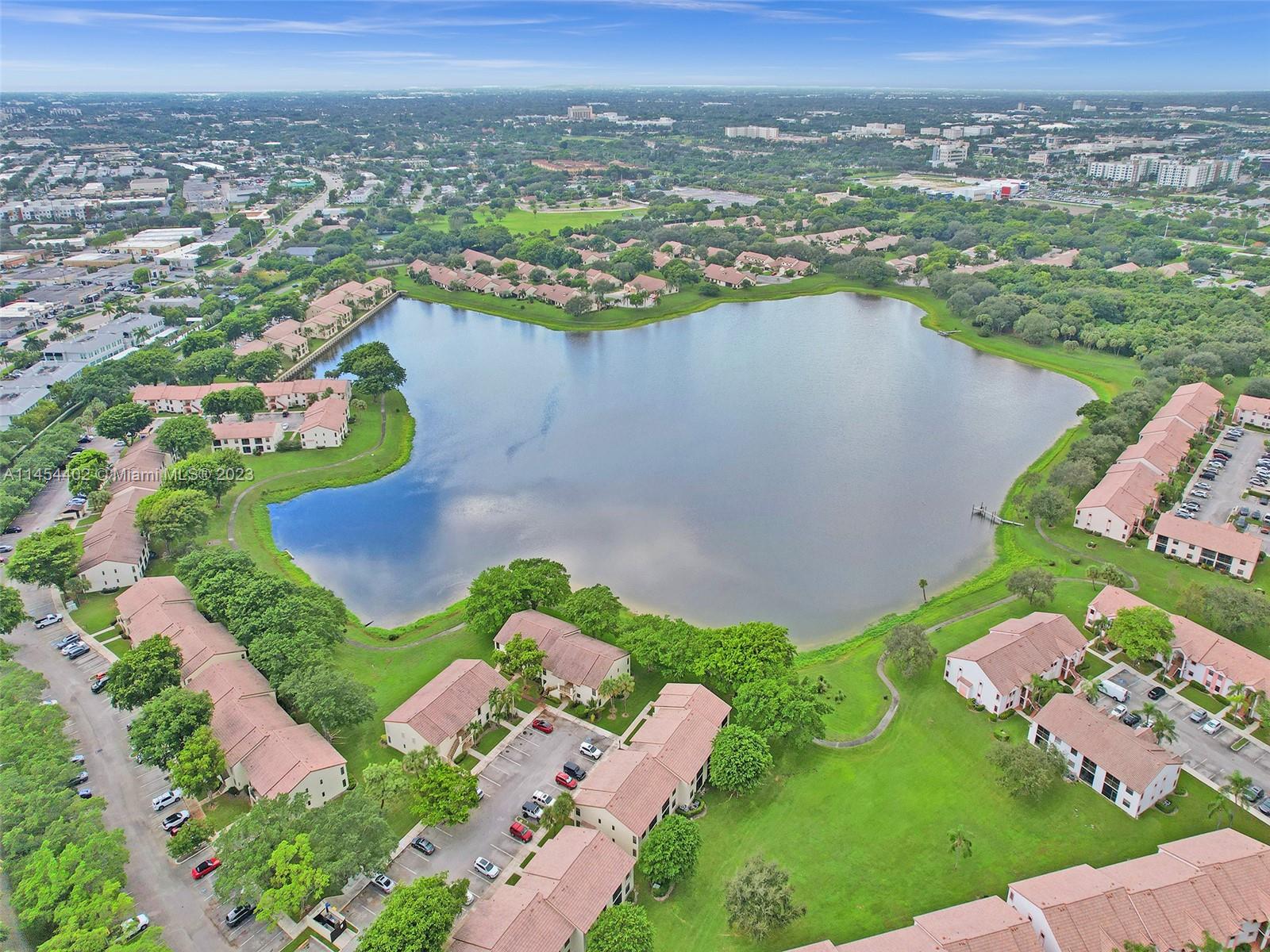 321 Olivewood Place, Unit O221 Boca Raton, FL 33431 - Photo 3 of 56 an aerial view of a house with a lake view