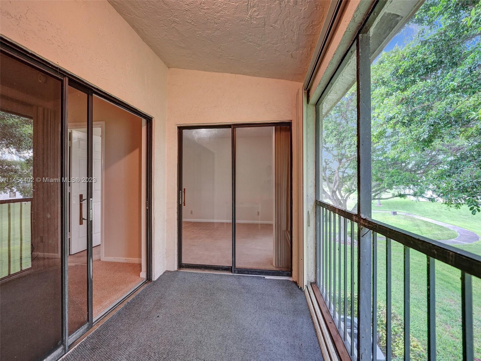 321 Olivewood Place, Unit O221 Boca Raton, FL 33431 - Photo 34 of 56 a view of a glass door and an entrance