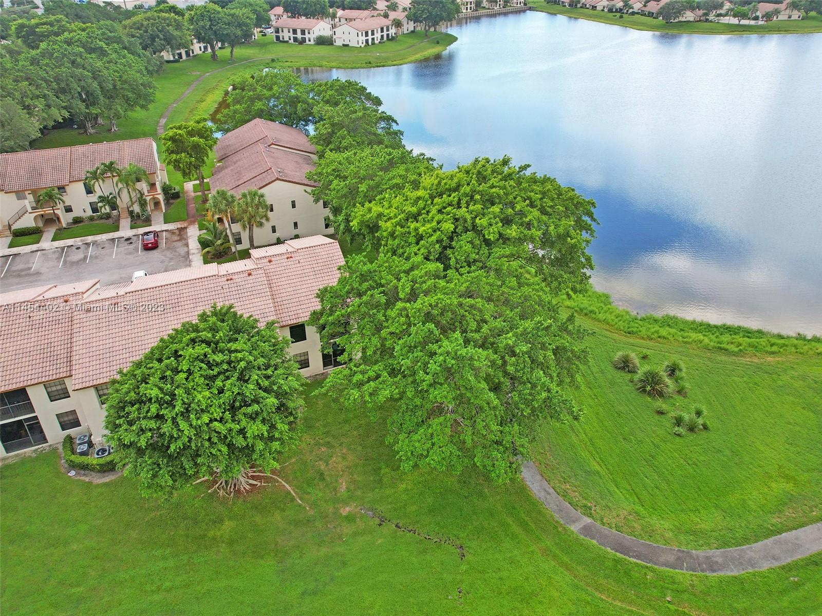 321 Olivewood Place, Unit O221 Boca Raton, FL 33431 - Photo 35 of 56 an aerial view of a house with a lake view
