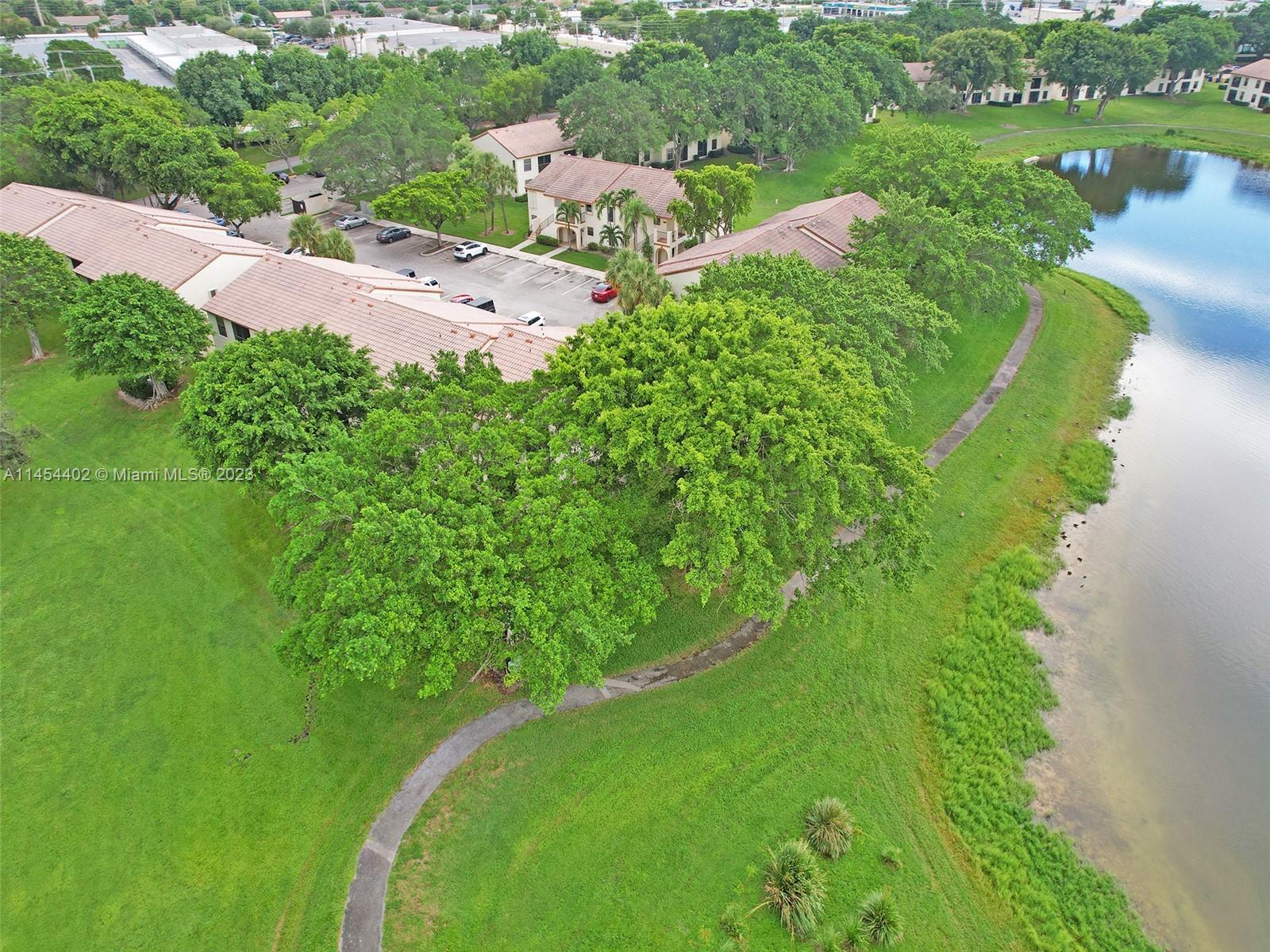 321 Olivewood Place, Unit O221 Boca Raton, FL 33431 - Photo 38 of 56 an aerial view of a house with a yard and lake view
