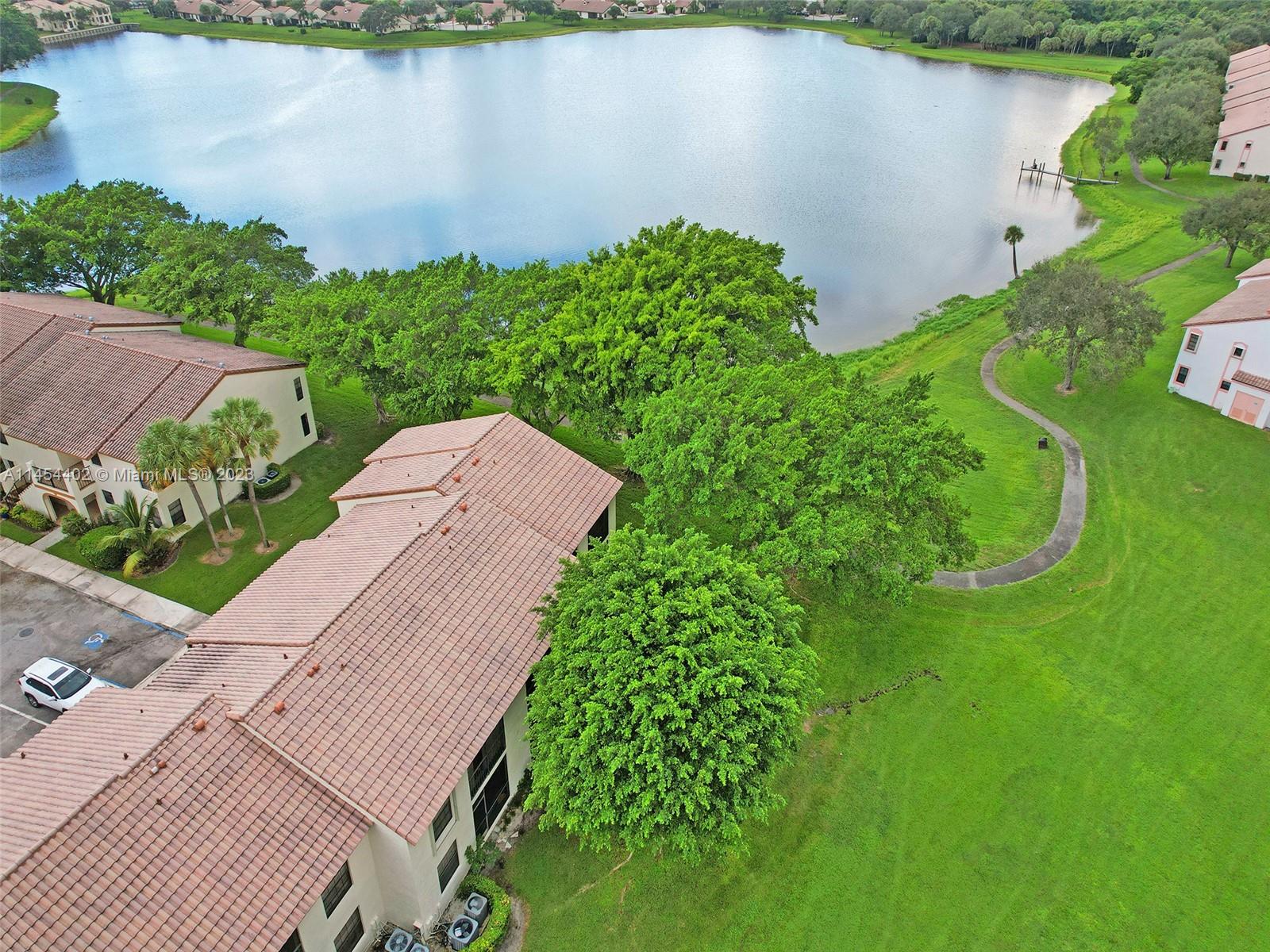 321 Olivewood Place, Unit O221 Boca Raton, FL 33431 - Photo 52 of 56 an aerial view of a house with a yard and lake view
