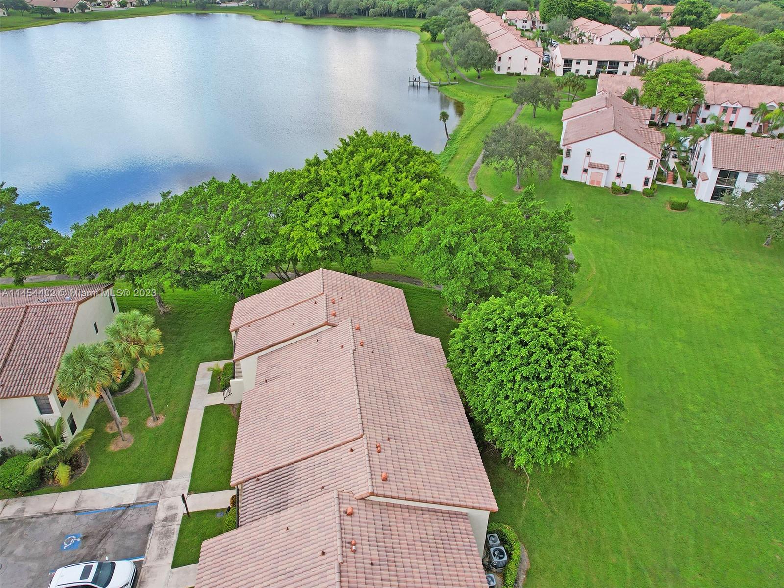 321 Olivewood Place, Unit O221 Boca Raton, FL 33431 - Photo 53 of 56 an aerial view of a house with a yard and lake view