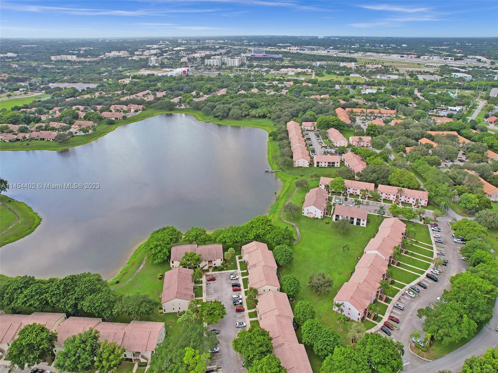 321 Olivewood Place, Unit O221 Boca Raton, FL 33431 - Photo 55 of 56 an aerial view of a city with lots of residential buildings ocean and mountain view in back