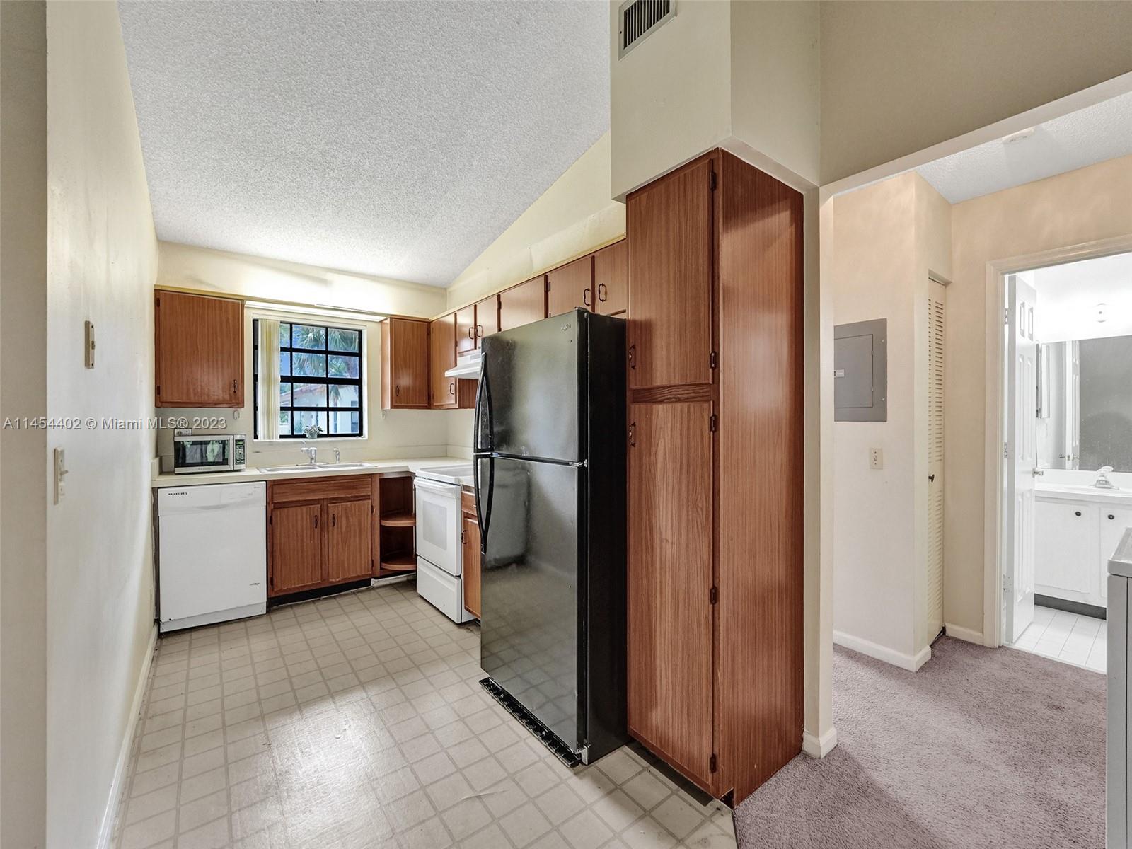 321 Olivewood Place, Unit O221 Boca Raton, FL 33431 - Photo 9 of 56 a kitchen with stainless steel appliances a refrigerator and a stove