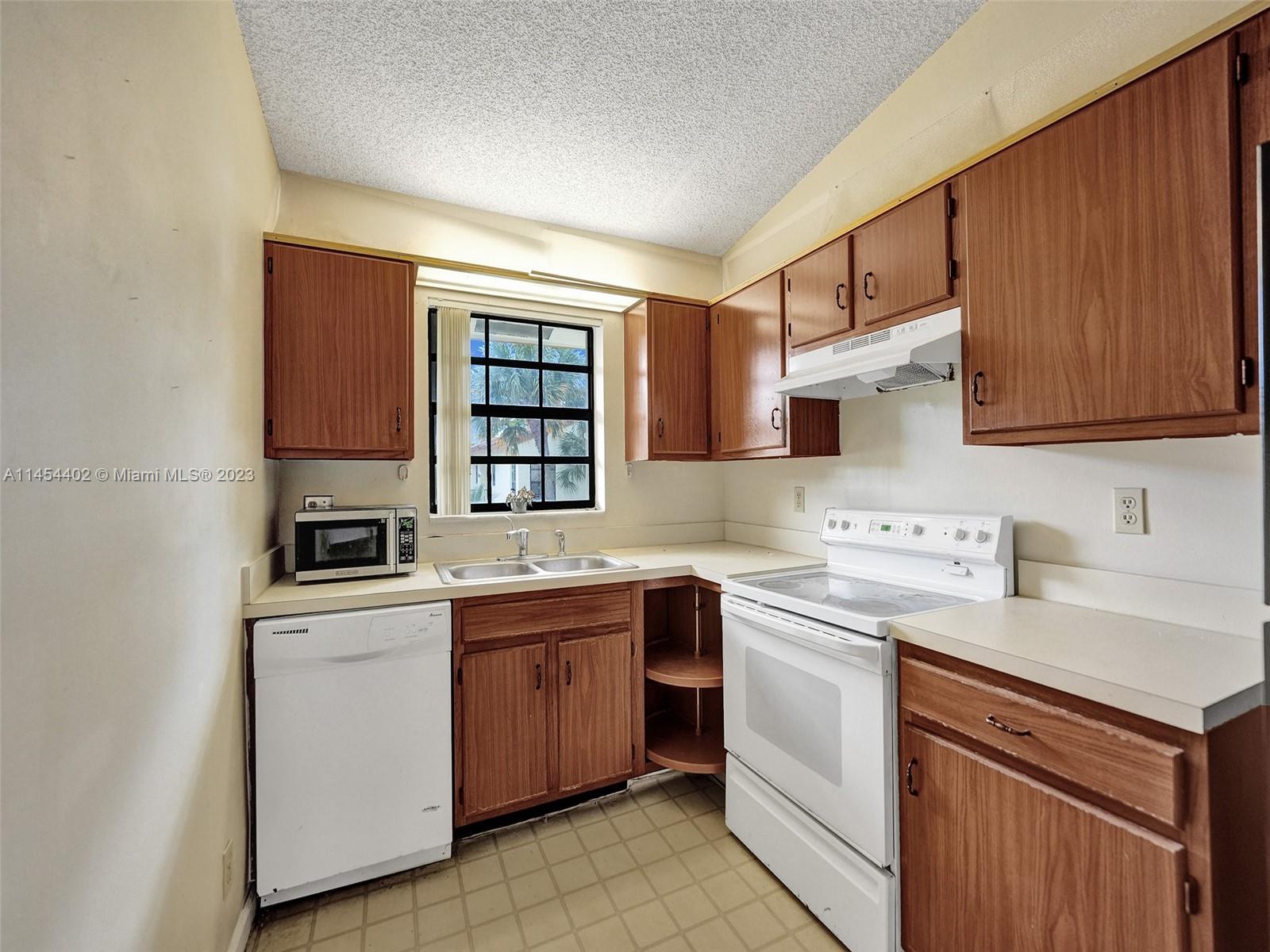 321 Olivewood Place, Unit O221 Boca Raton, FL 33431 - Photo 10 of 56 a kitchen with a sink stove and cabinets
