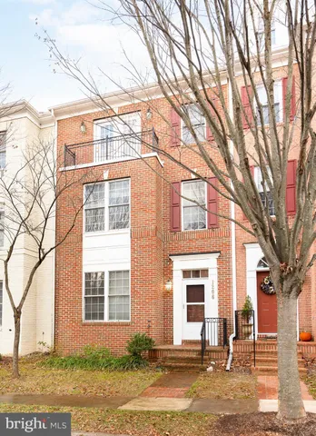 front view of a brick house with a yard