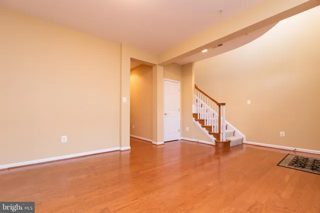 a view of an empty room with stairs and ventilation