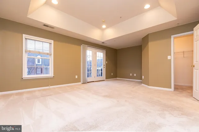 a view of an empty room with windows